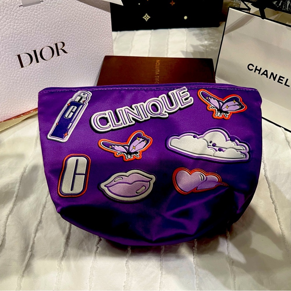 Clinique EUC purple cosmetic pouch. 10 in by 6 in